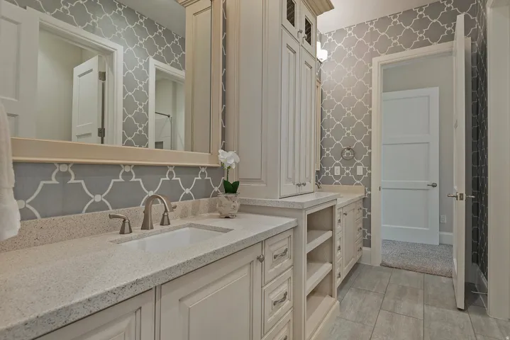 Bathroom featuring vanity and wallpapered walls