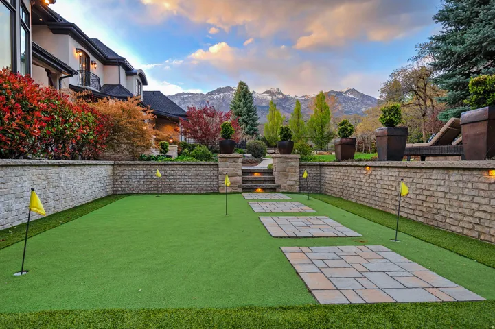 View of yard featuring a patio, an area to practice putting, and a mountain view