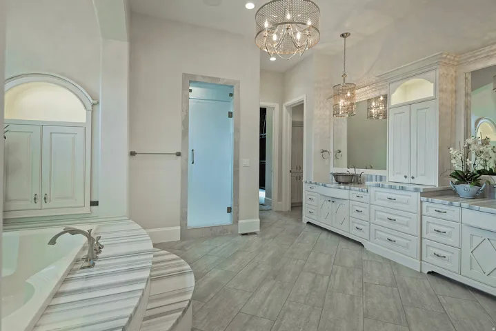Bathroom with vanity, suspended lighting, wood finish floors, and a stall shower
