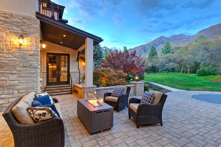 Patio / terrace featuring french doors, an outdoor living space with a fire pit, a lawn, a patio, and a mountain view