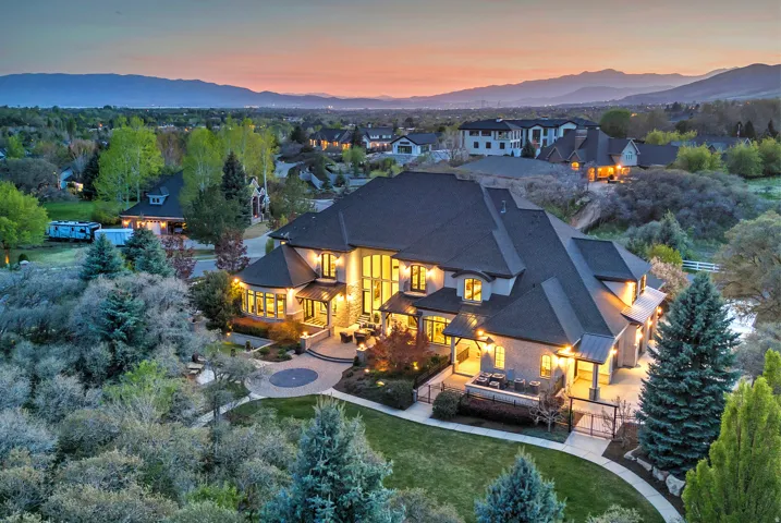 Rear view of property with a fire pit, a patio, a mountain view, and a yard