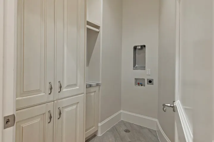 Laundry room featuring cabinet space, light wood-style flooring, and washer hookup