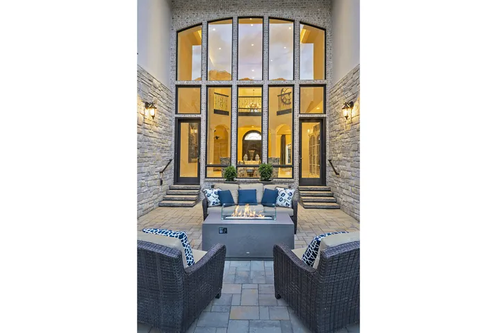 View of patio / terrace featuring entry steps and an outdoor living space with a fire pit