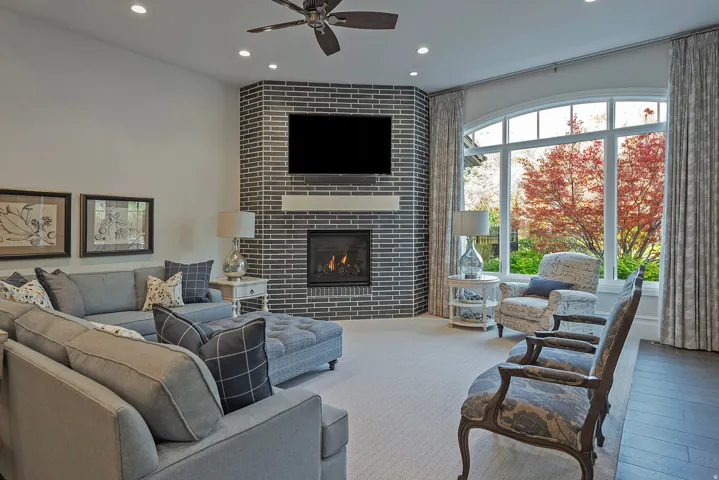 Living room with a ceiling fan, a tile fireplace, recessed lighting, and hardwood / wood-style floors