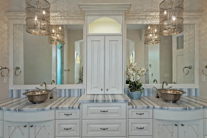 Full bath with suspended lighting and double vanity