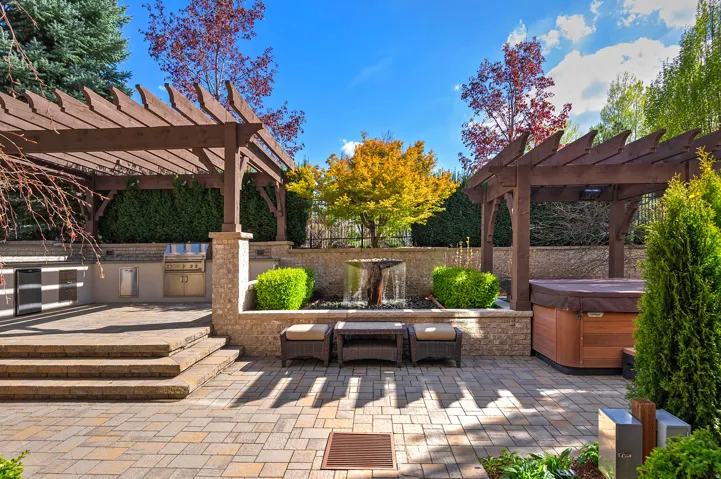 View of patio with a pergola, area for grilling, and a hot tub