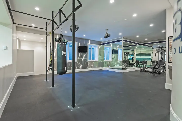 Workout area with dark flooring and recessed lighting