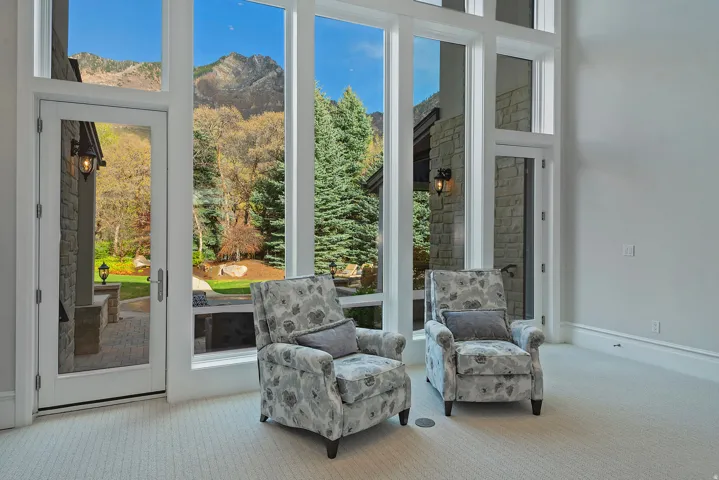 Doorway with carpet floors, a mountain view, and a high ceiling