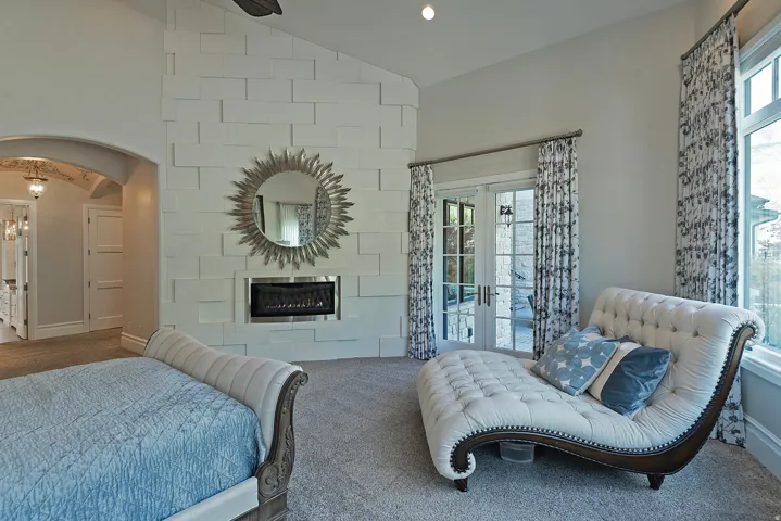 Bedroom with arched walkways, lofted ceiling, carpet, french doors, and recessed lighting