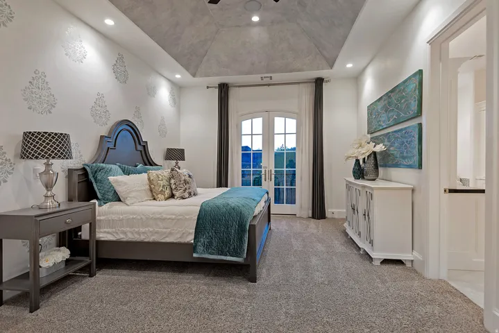 Bedroom with access to outside, french doors, light colored carpet, a tray ceiling, and ceiling fan