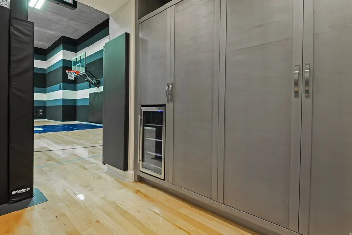Interior space with light wood-style floors and wine cooler