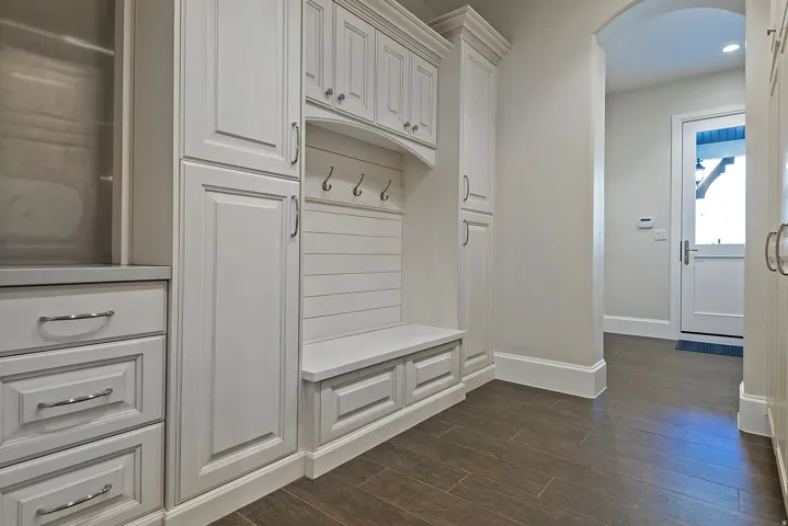 Mudroom featuring arched walkways, dark wood-style flooring, and recessed lighting