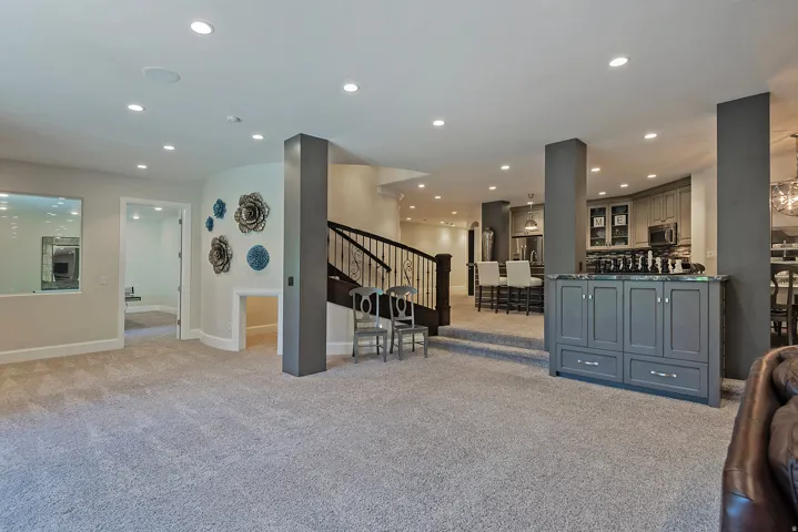 Living area with recessed lighting and light colored carpet