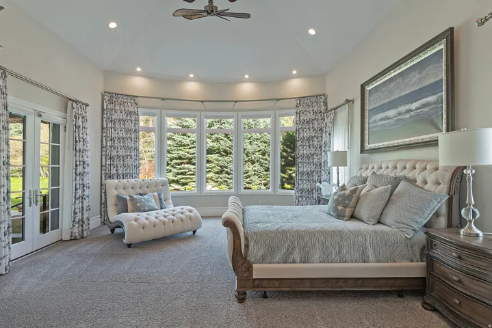 Bedroom with access to exterior, carpet, vaulted ceiling, french doors, and a ceiling fan