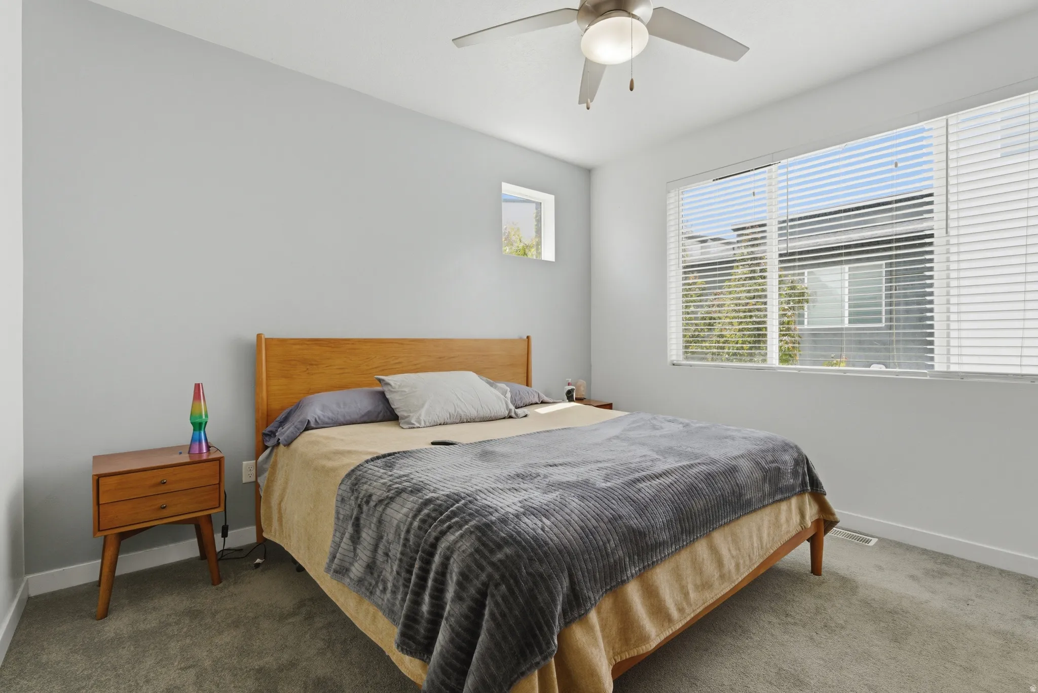 Carpeted bedroom featuring baseboards and ceiling fan