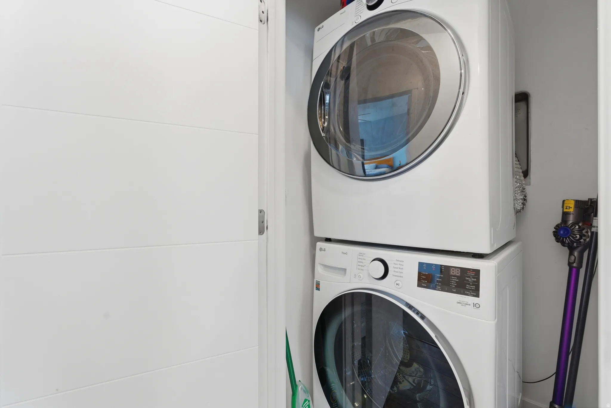 Laundry area featuring stacked washer / dryer