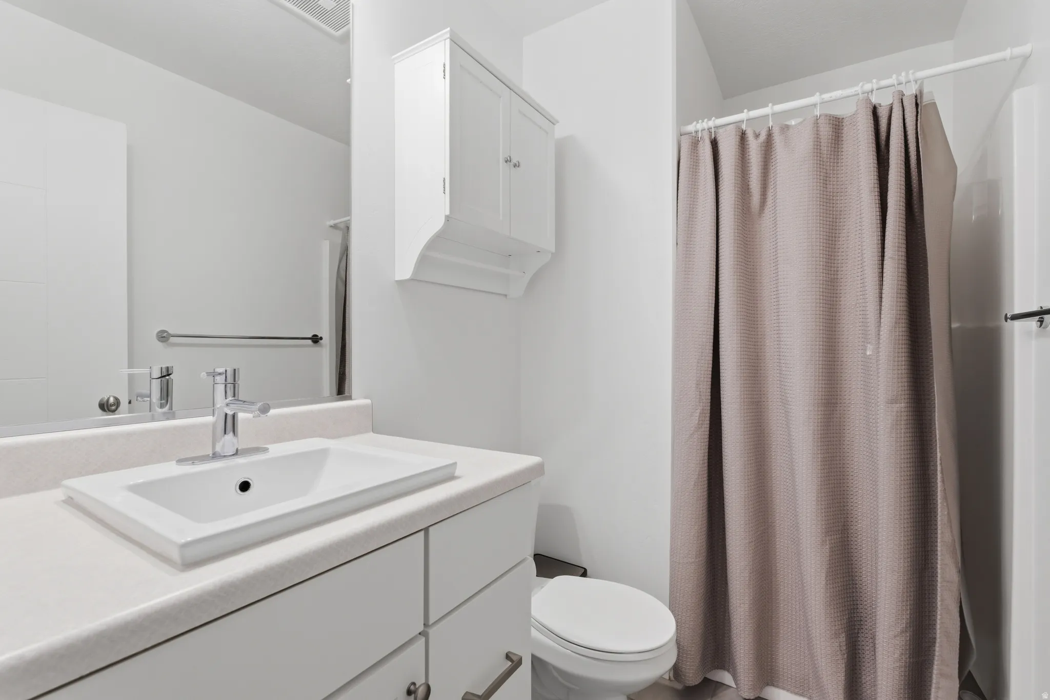 Full bath featuring vanity and a shower with curtain