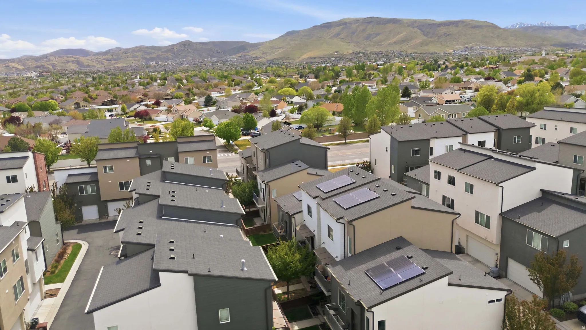 Aerial view of residential area featuring a mountainous background