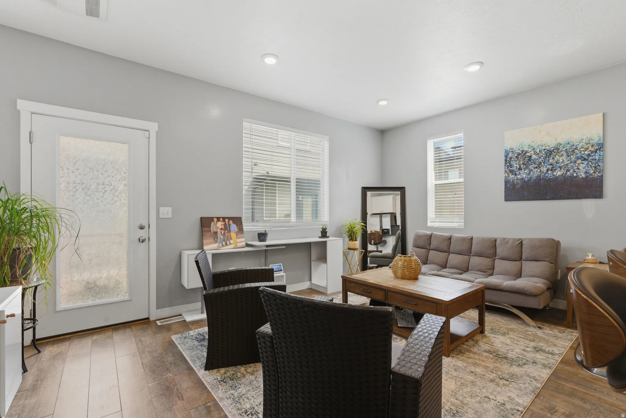 Living area with wood-type flooring and recessed lighting