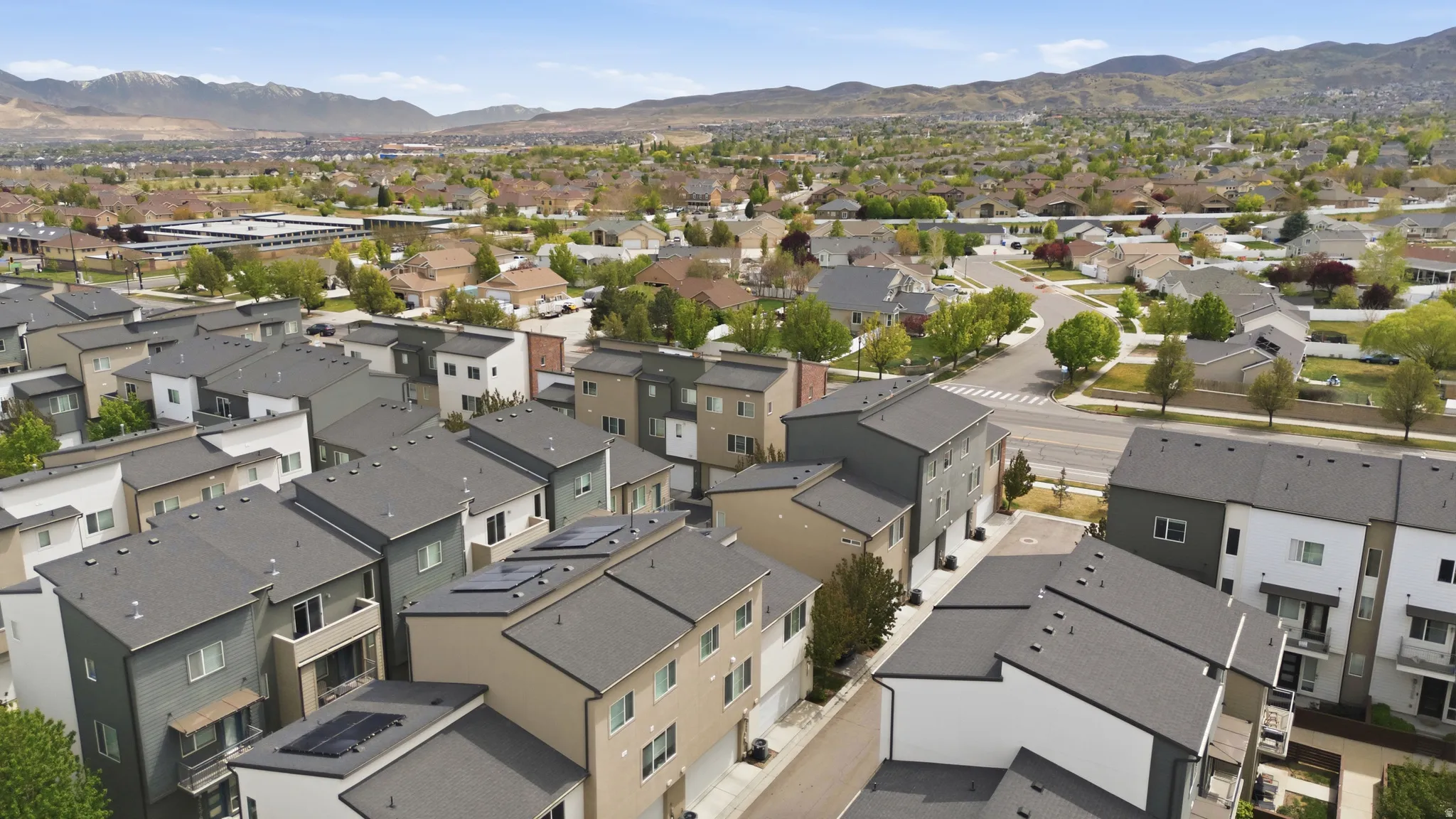 Aerial perspective of suburban area with a mountainous background