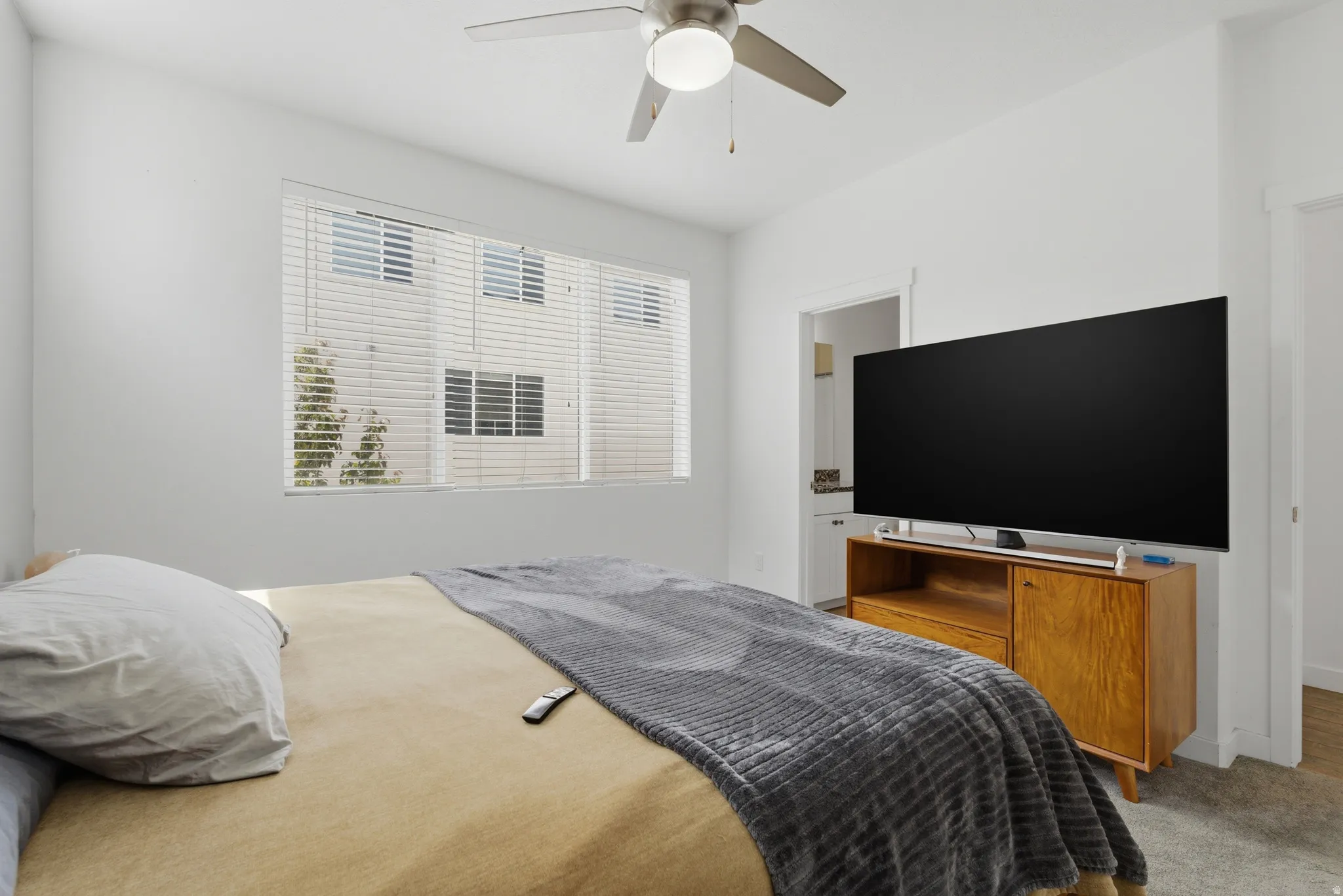 Bedroom with a ceiling fan and carpet