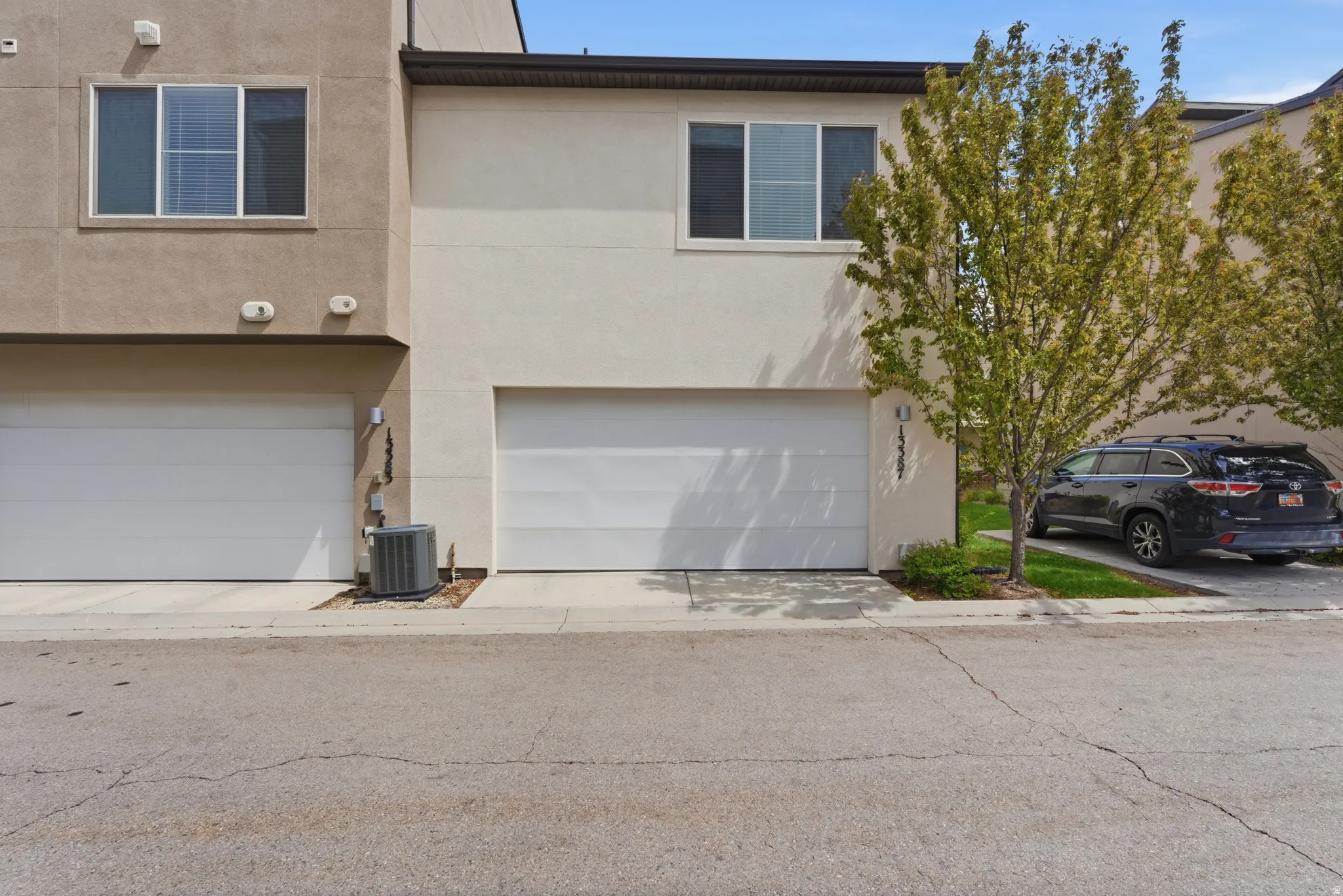 View of front of property with an attached garage and stucco siding