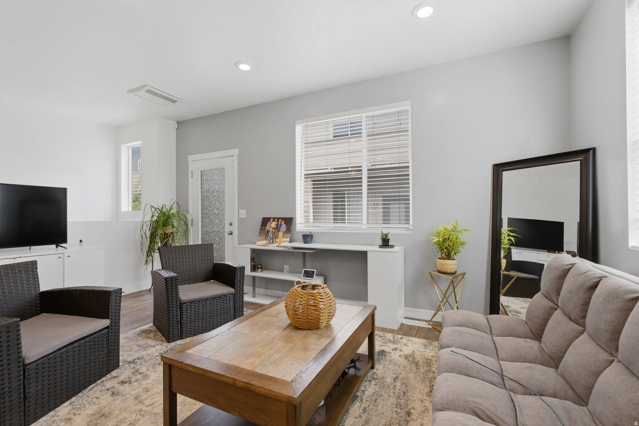 Living area with wood finished floors and recessed lighting