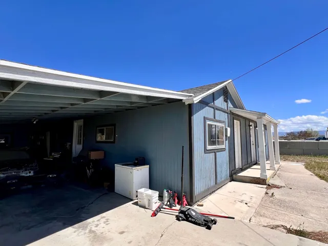 View of property exterior with a carport