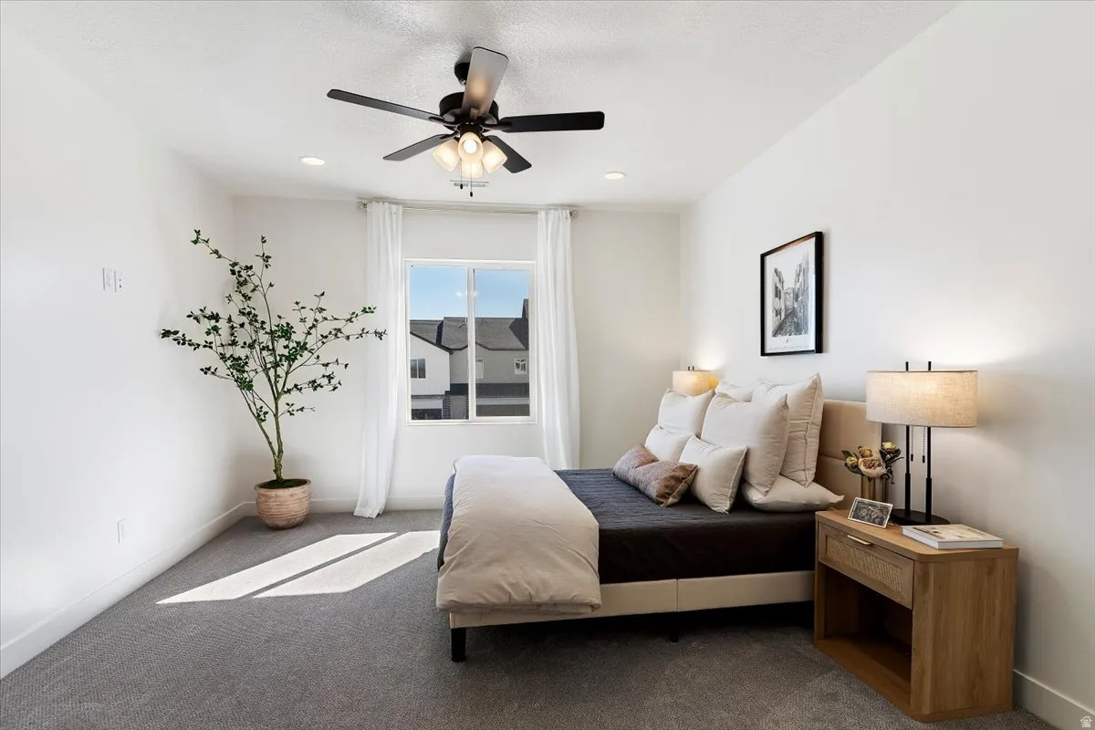 Bedroom with carpet and ceiling fan