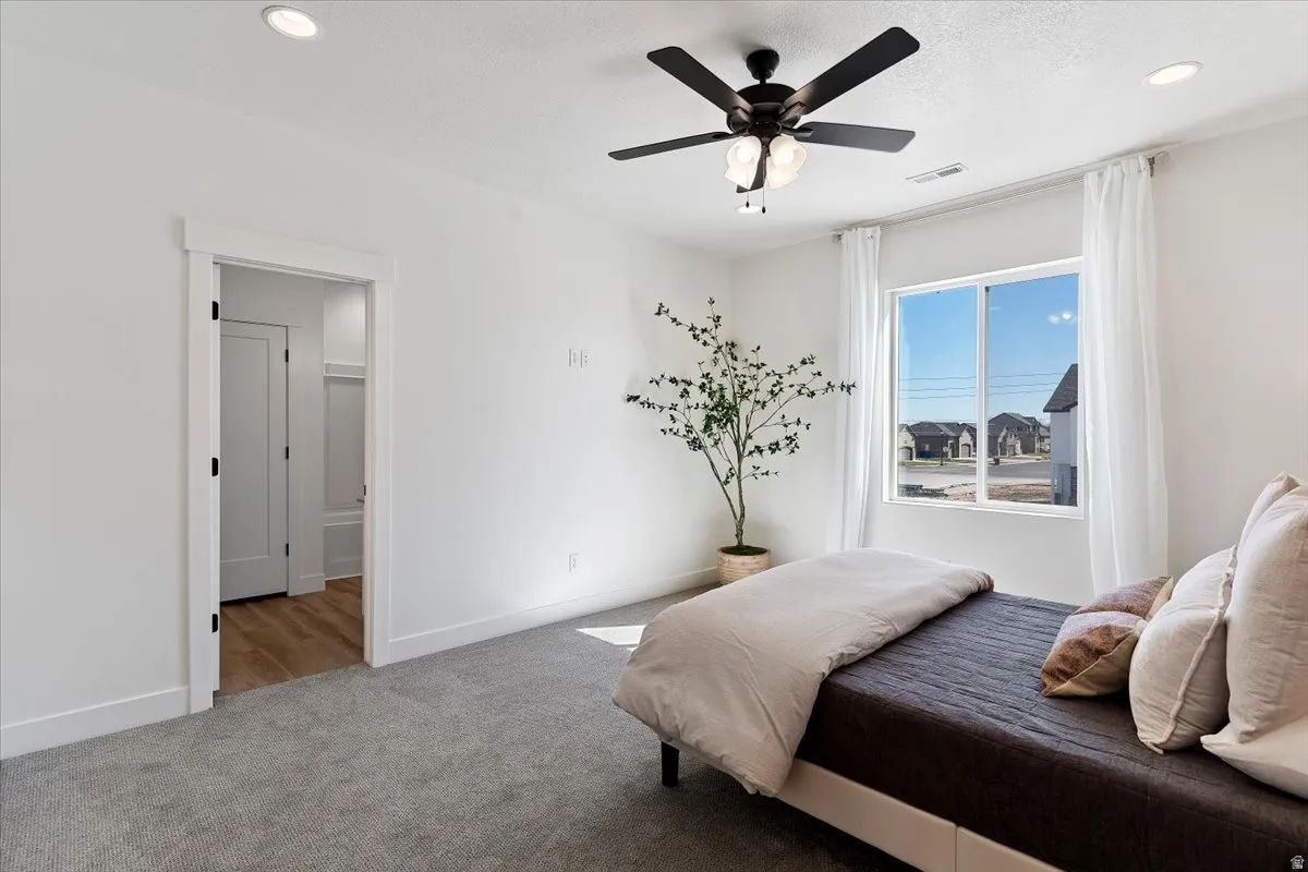 Bedroom featuring ceiling fan, carpet floors, and recessed lighting
