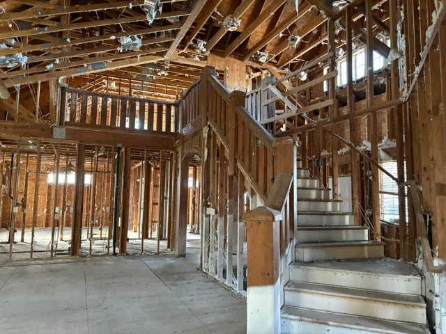 Stairs with a high ceiling and plenty of natural light