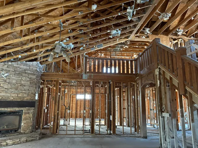 Misc room featuring a high ceiling and a fireplace