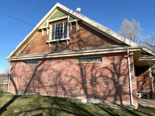 View of property exterior with brick siding