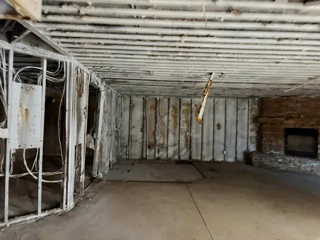 Basement with a stone fireplace