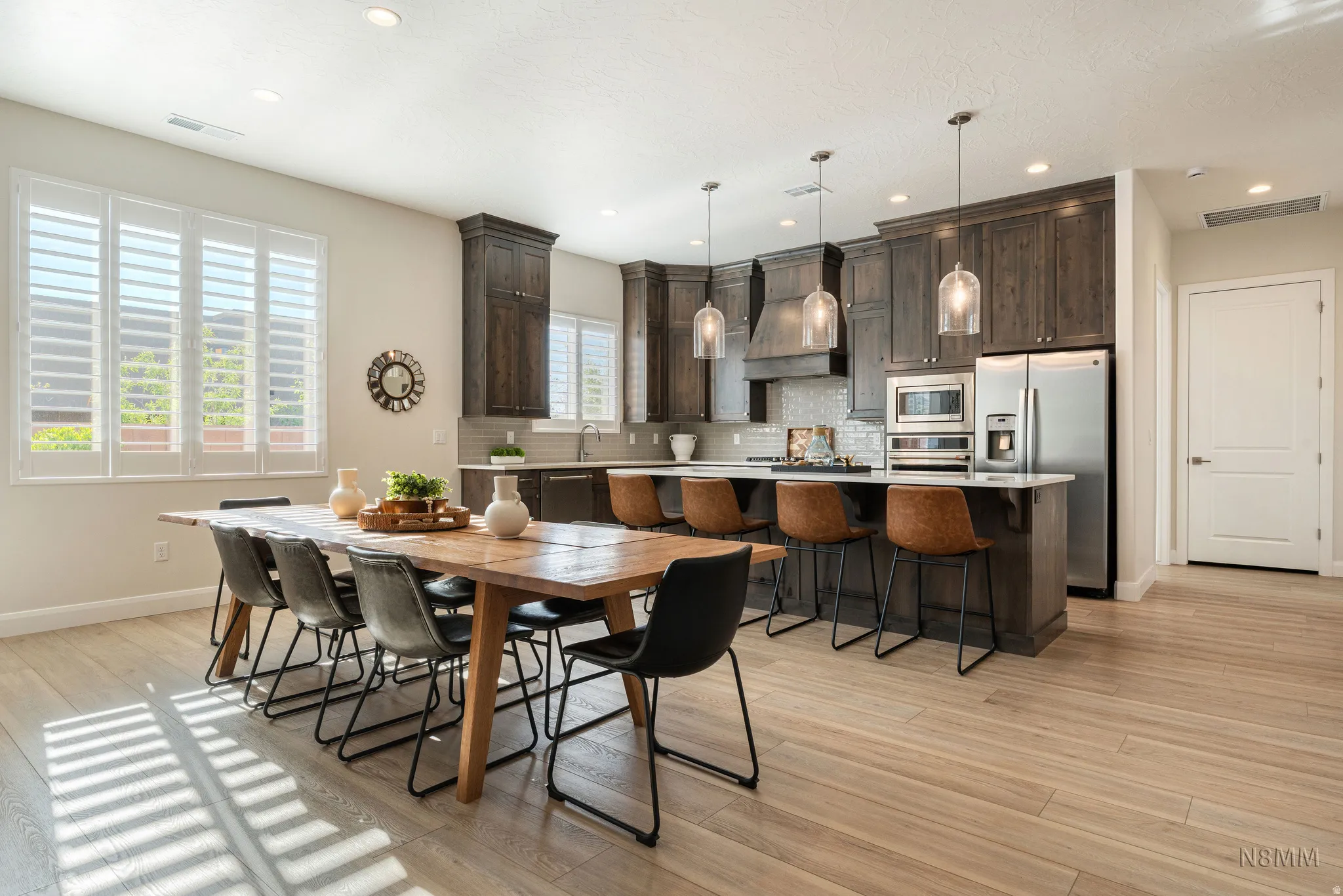 Dining area featuring light wood-type flooring and recessed lighting