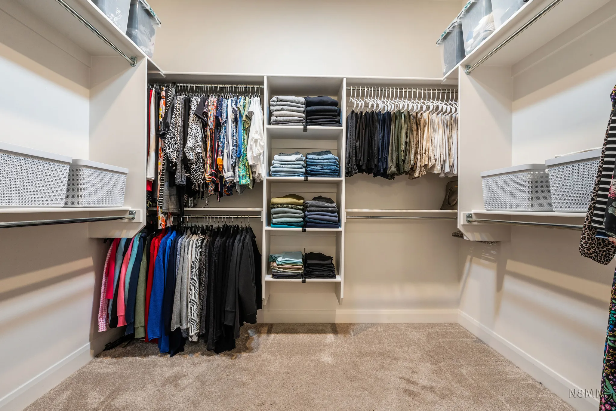 Walk in closet featuring light colored carpet