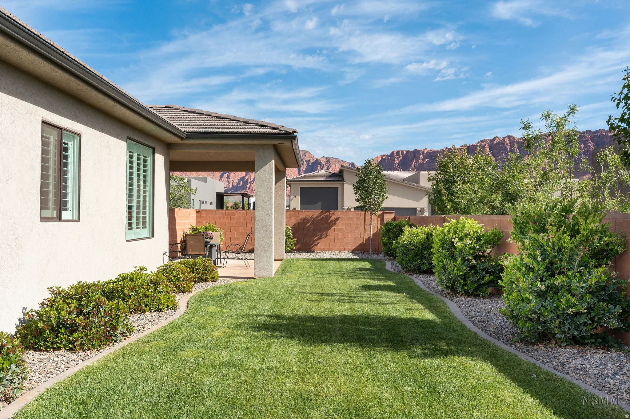 Fenced backyard featuring a patio and a mountain view