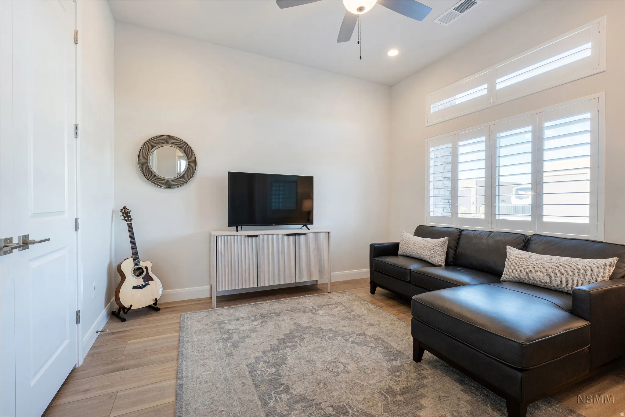 Living room featuring ceiling fan, light wood-style floors, and recessed lighting