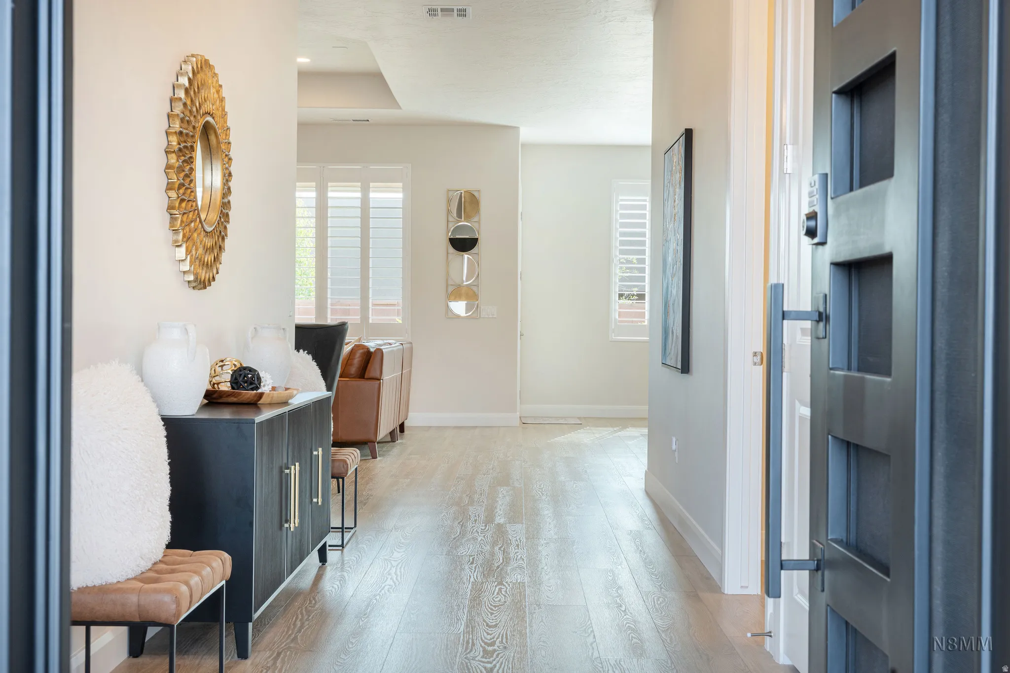 Foyer entrance with light wood finished floors and baseboards