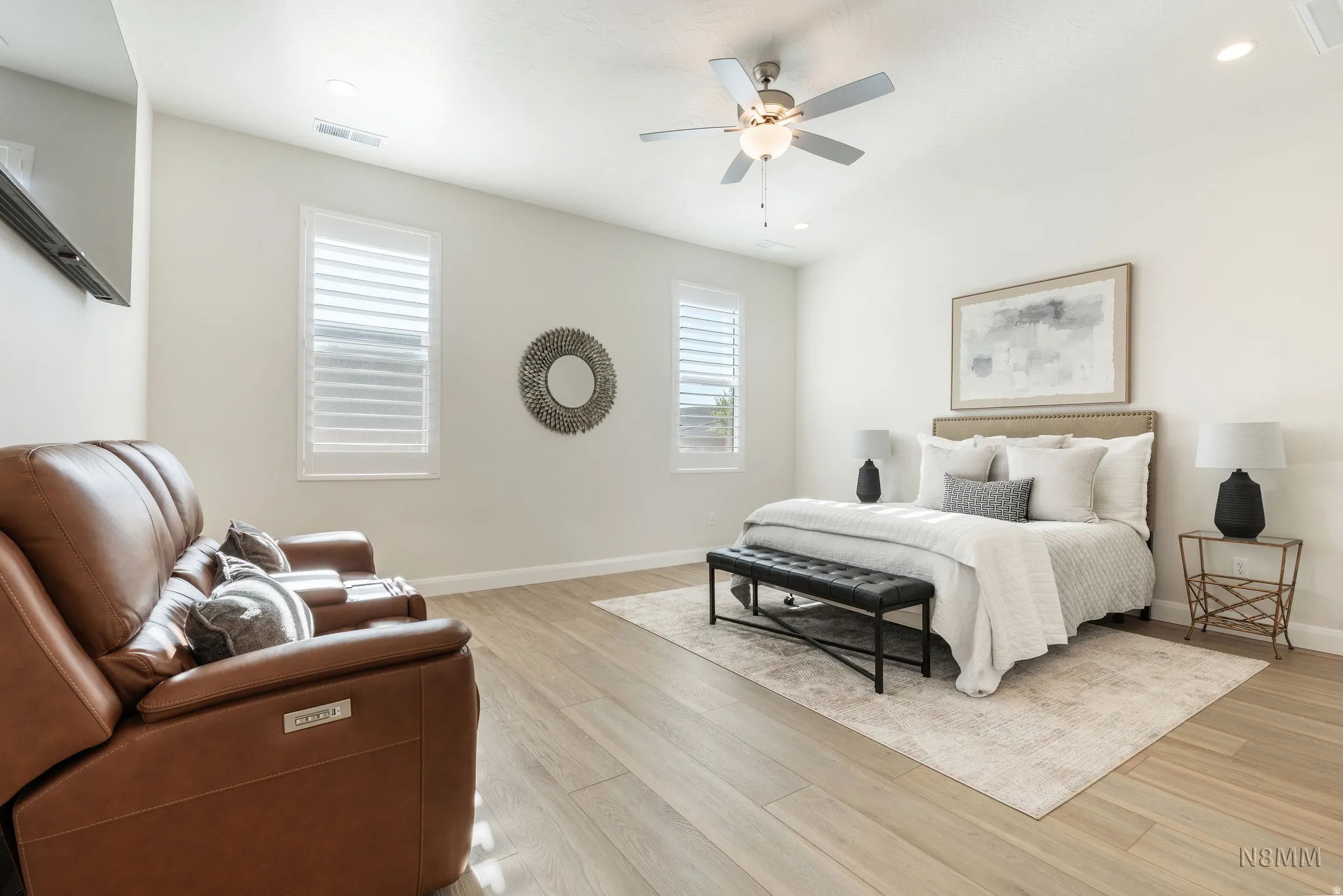 Bedroom with light wood finished floors, ceiling fan, and recessed lighting