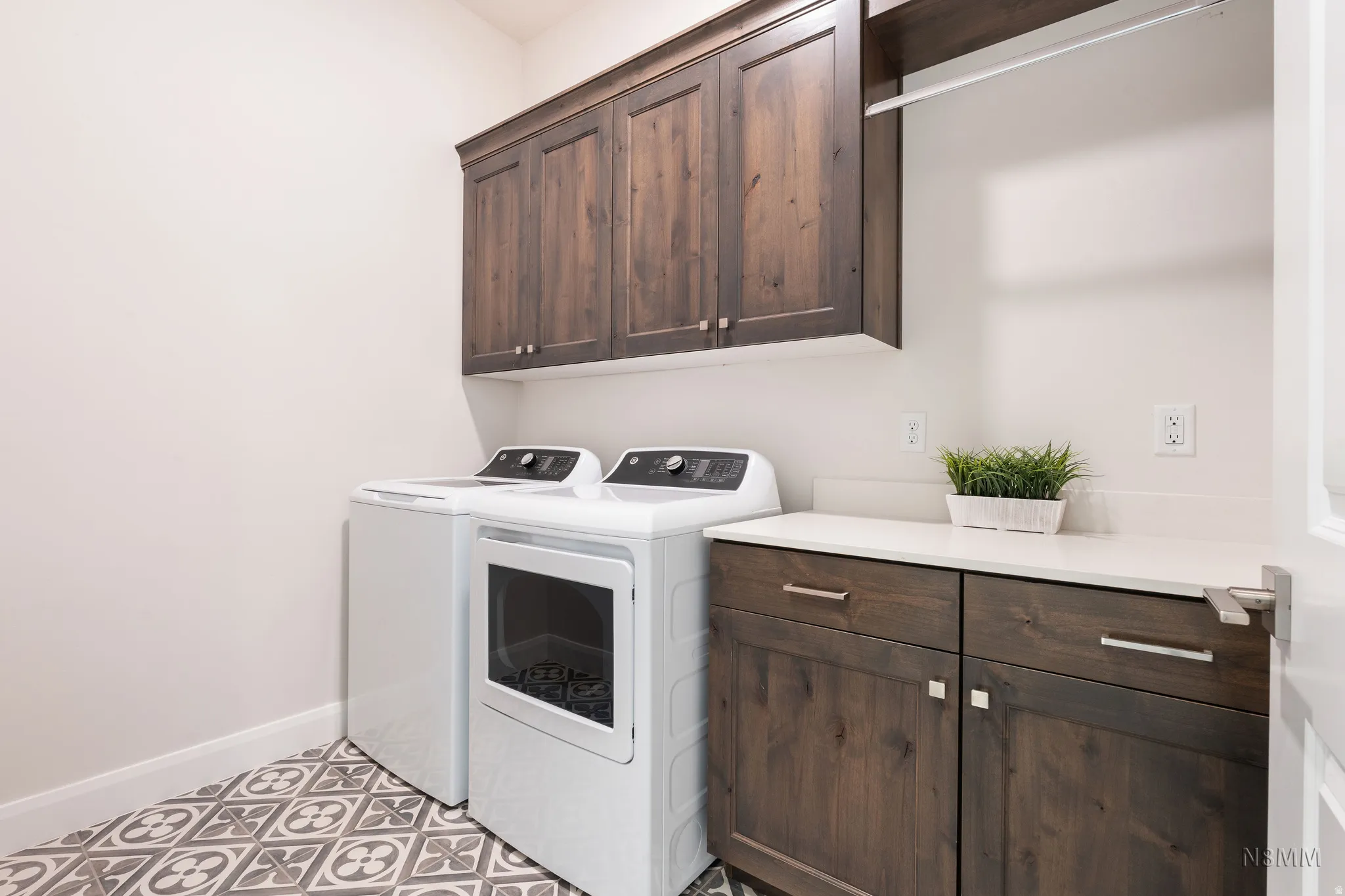 Laundry room featuring cabinet space, washer and clothes dryer, and light tile patterned floors