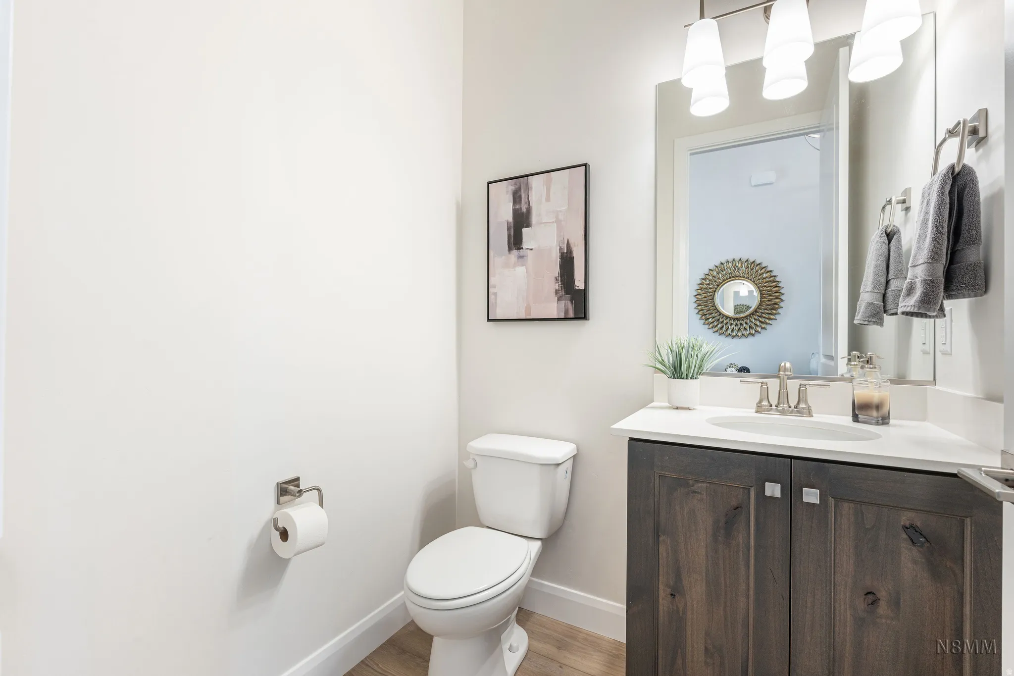 Half bathroom featuring vanity and light wood-style flooring