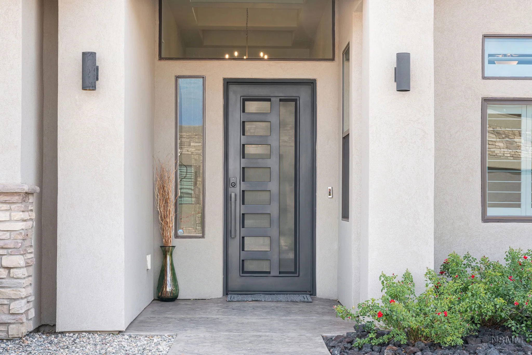 View of exterior entry featuring stucco siding