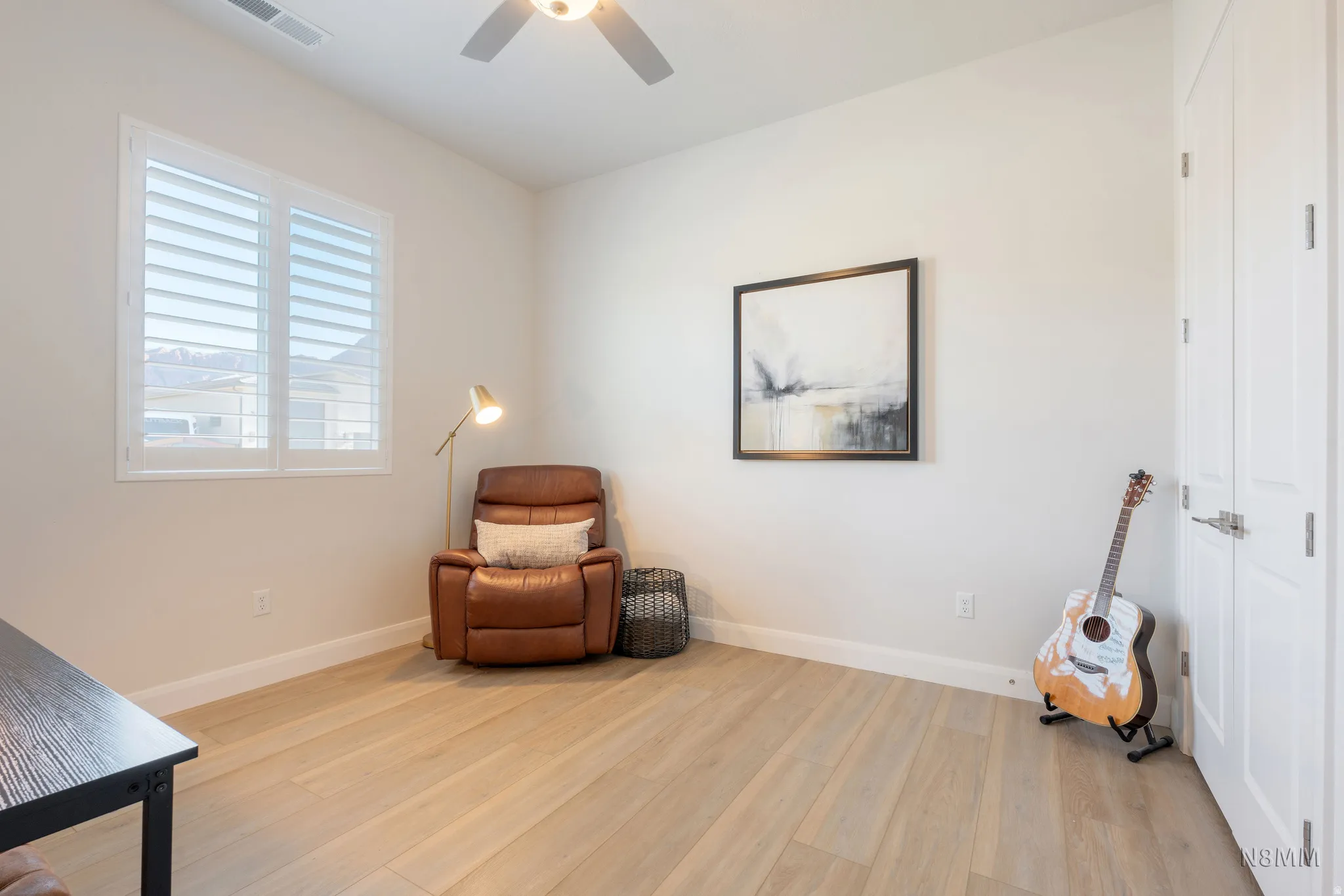 Living area featuring light wood-style flooring and ceiling fan