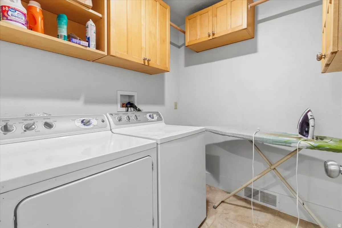 Laundry area with washer and dryer and cabinet space