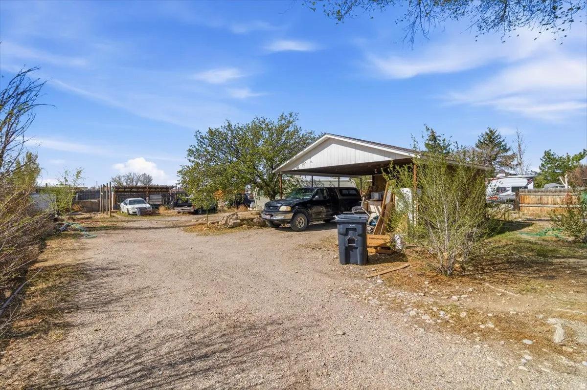 View of front of house with driveway and a carport