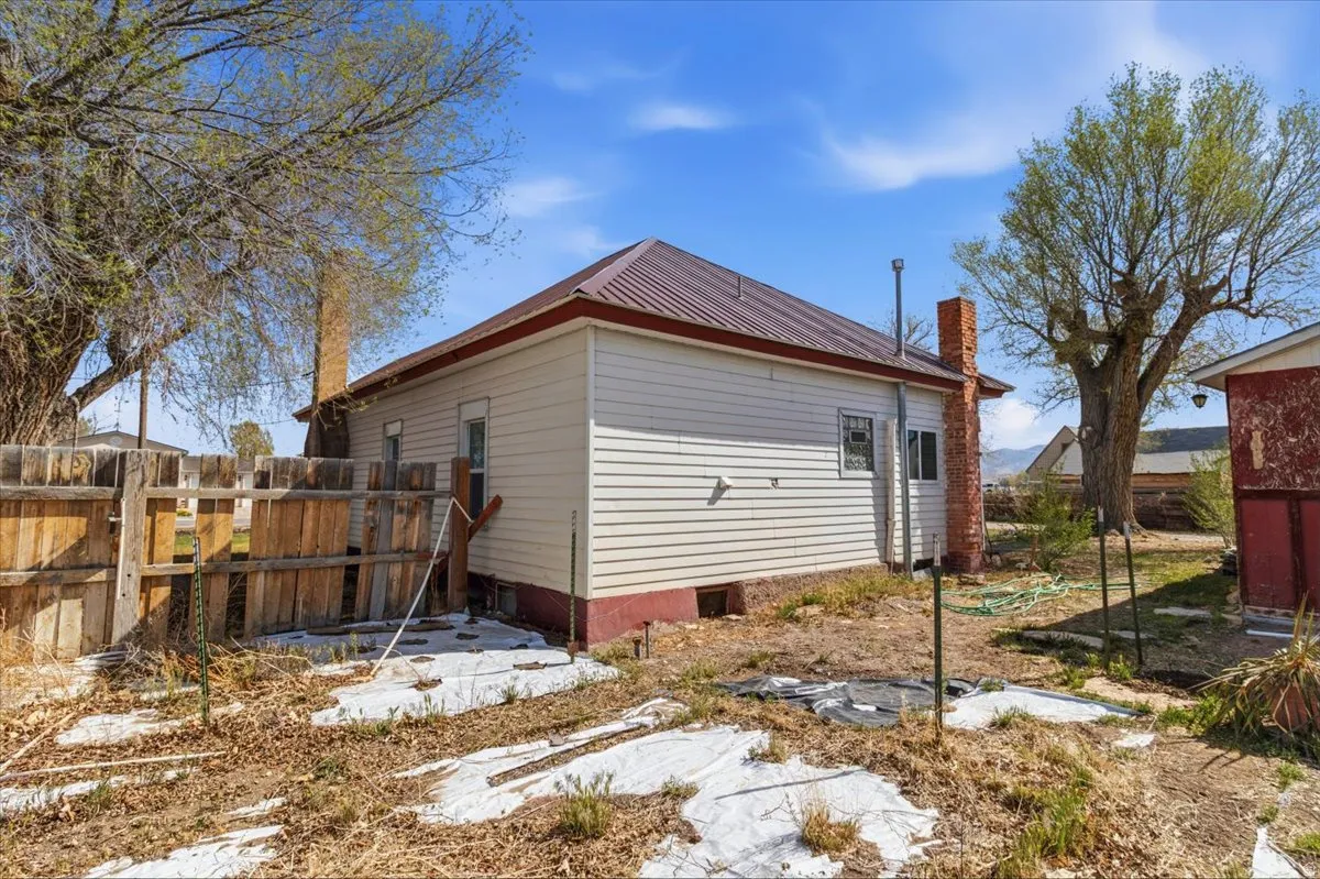 View of side of property with a metal roof and a chimney