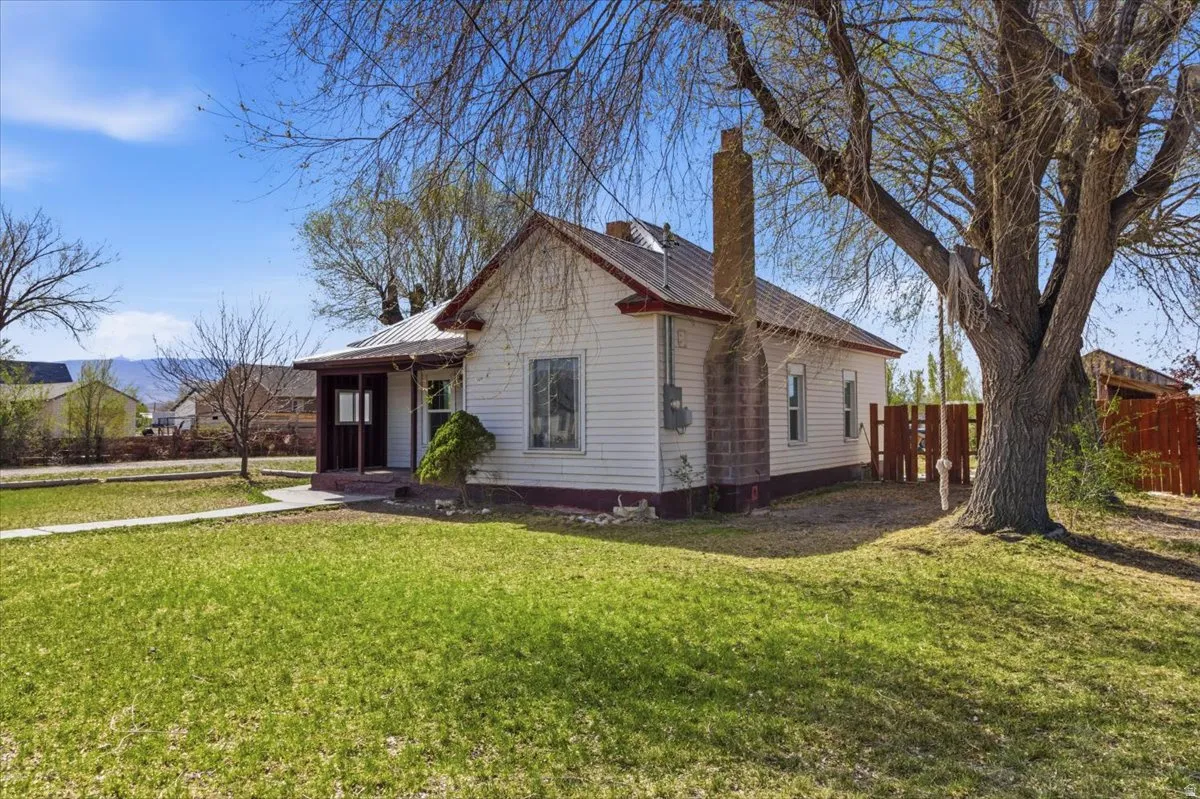 View of front of property with a metal roof and a chimney