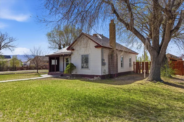 View of front of property with a metal roof and a chimney