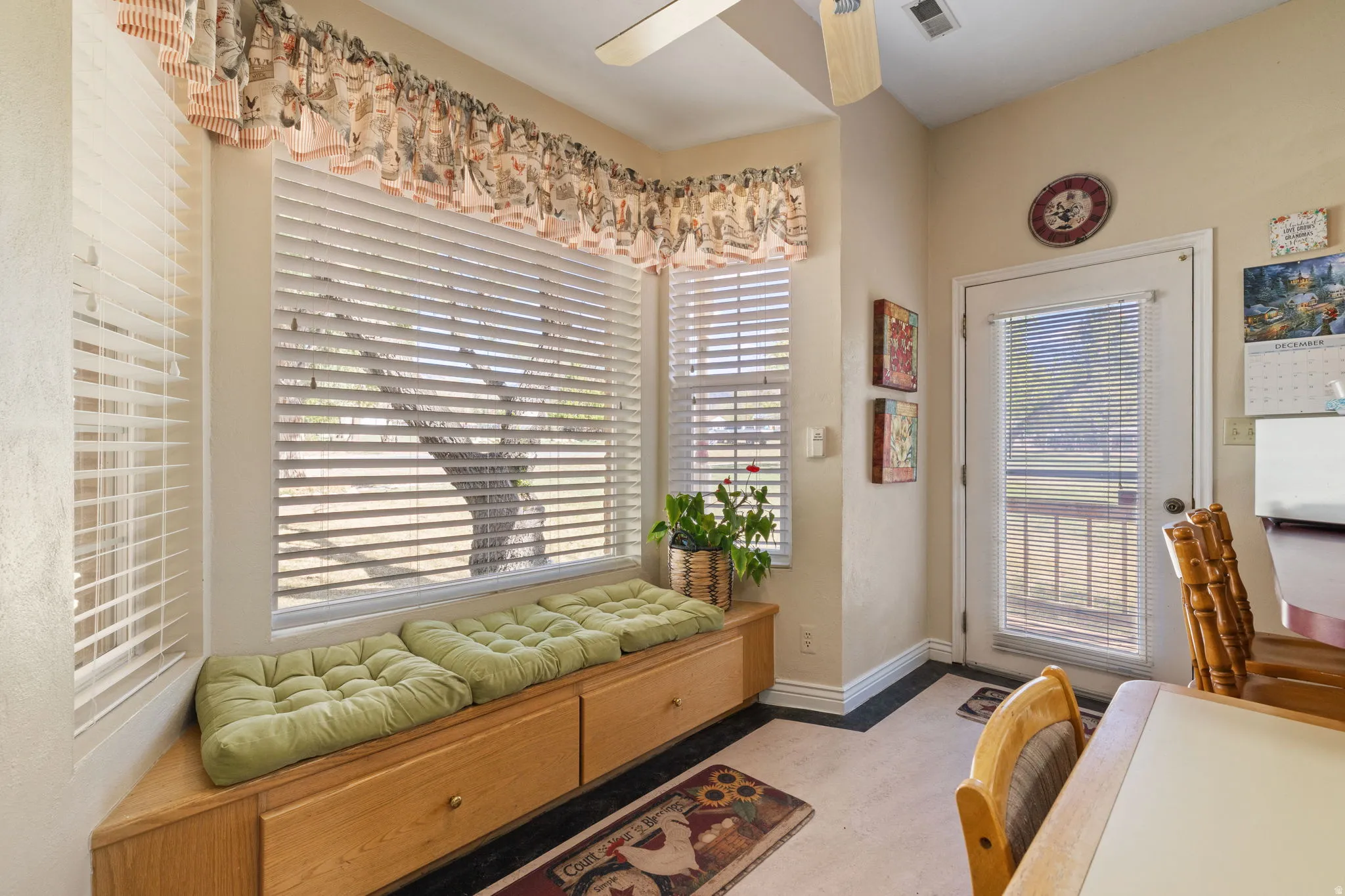 Country style kitchen with stainless steel appliances, accent brick wall and ample lighting. Charming window nook.